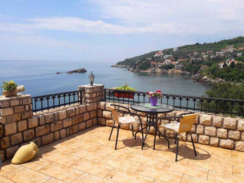 Balcony with wrought iron railing above the bay